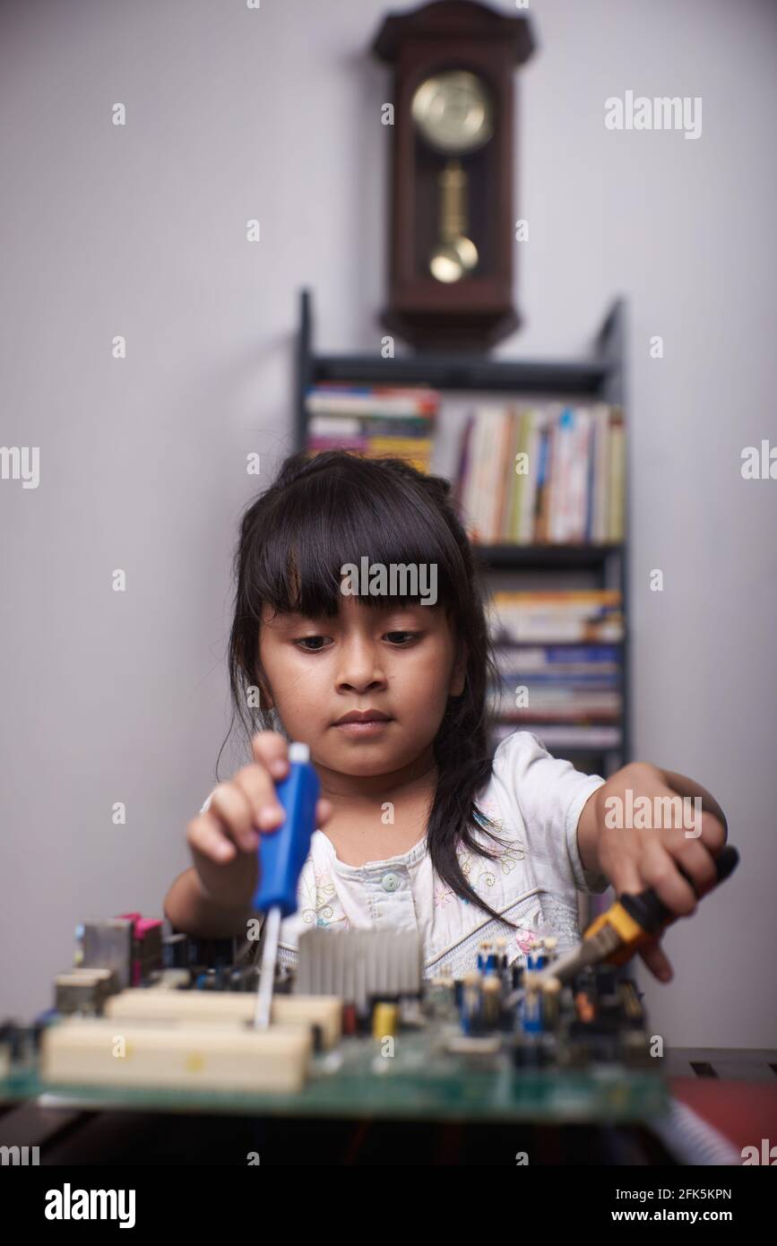 Little asian girl studying computer hardware Stock Photo - Alamy