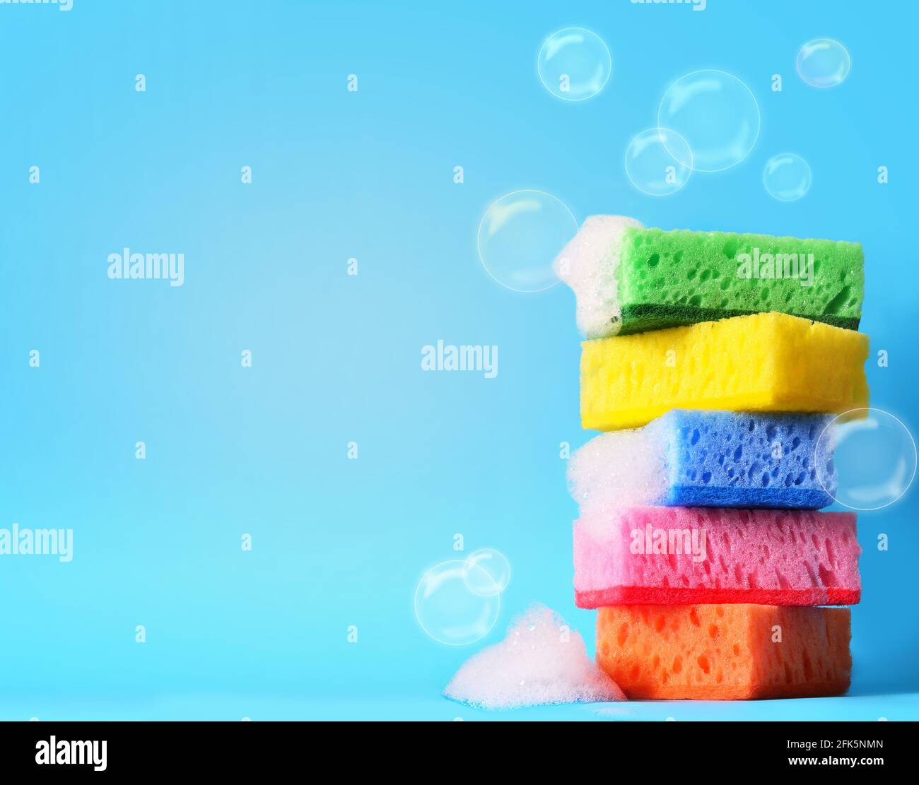 sponges cleaning kit isolated on blue background and foam Stock Photo