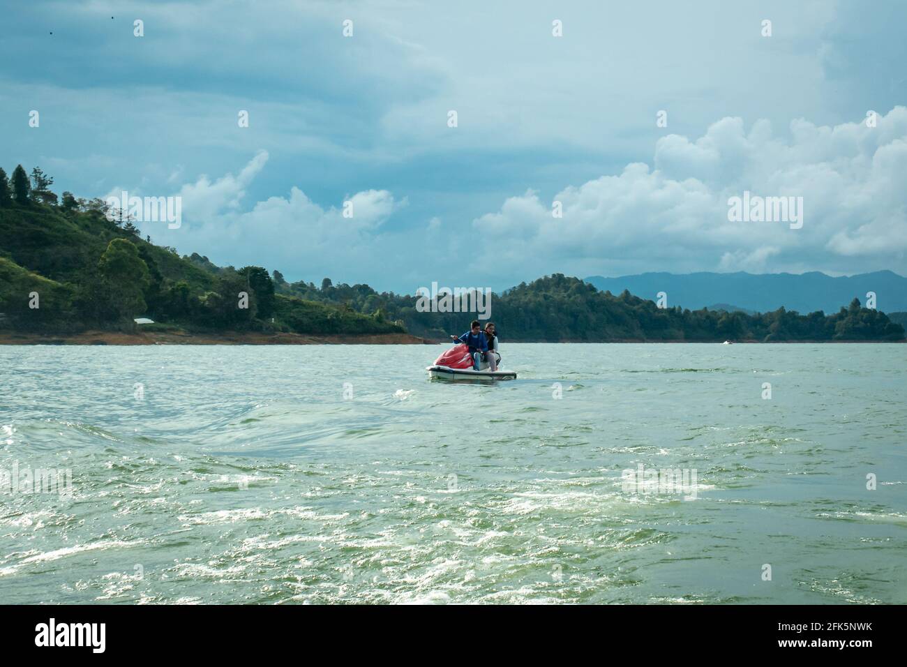 Guatapé, Antioquia, Colombia - April 3 2021: Latin Couple Driving a Jetsky in the Waters of the Dam near Peñol Stock Photo