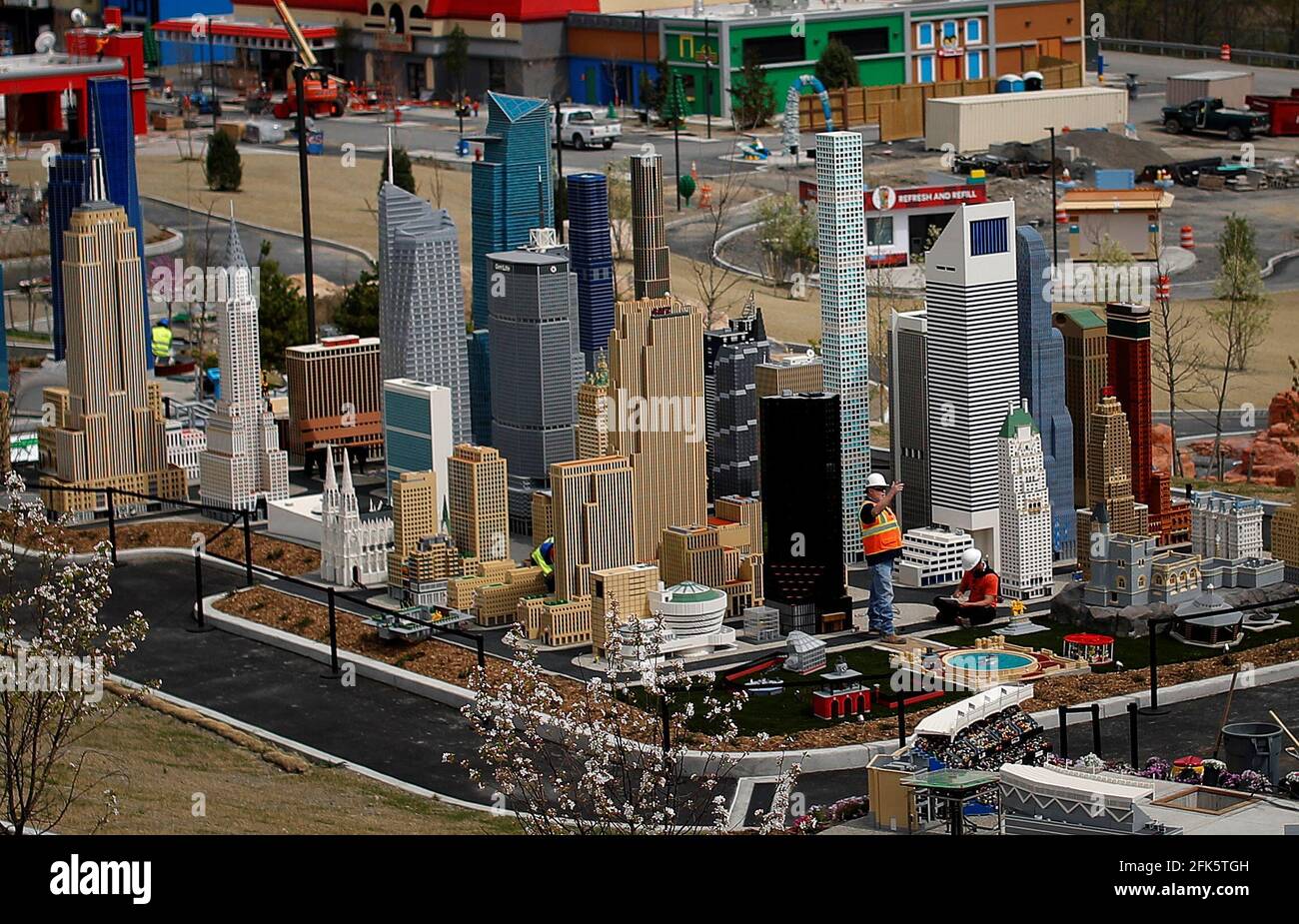 Workers are pictured in the Lego Manhattan section of the New York City  exhibit in the "Miniland" area of the new Legoland New York Resort theme  park during a press preview of