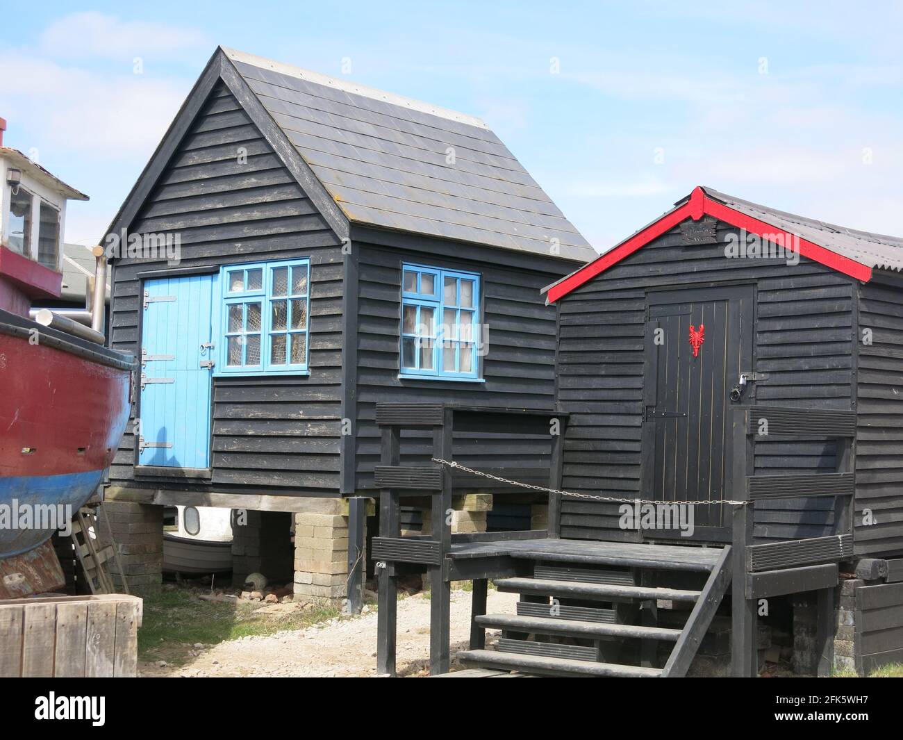Southwold Harbour is a popular tourist destination with the attractive black weatherboard fishermen's huts & fishing heritage along the River Blyth. Stock Photo