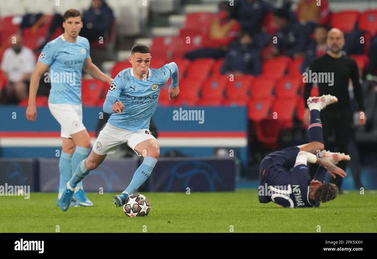 Manchester City's Phil Foden in action as Paris Saint-Germain's Neymar takes a tumble during the UEFA Champions League Semi Final, first leg, at the Parc des Princes in Paris, France. Picture date: Wednesday April 28, 2021. Stock Photo