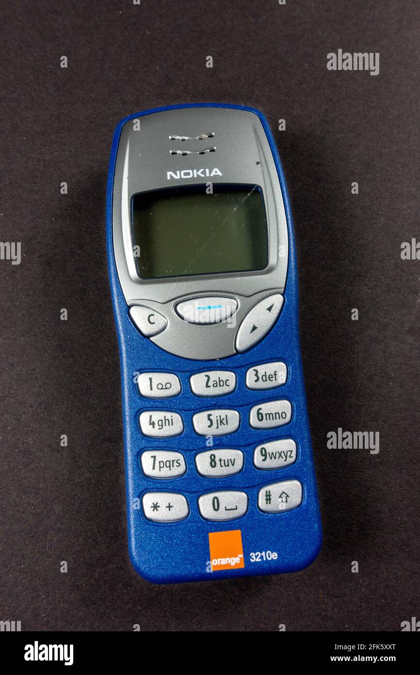 An Orange Nokia 3210e phone (the Nokia 3210e was originally released in 1999), Stock Photo
