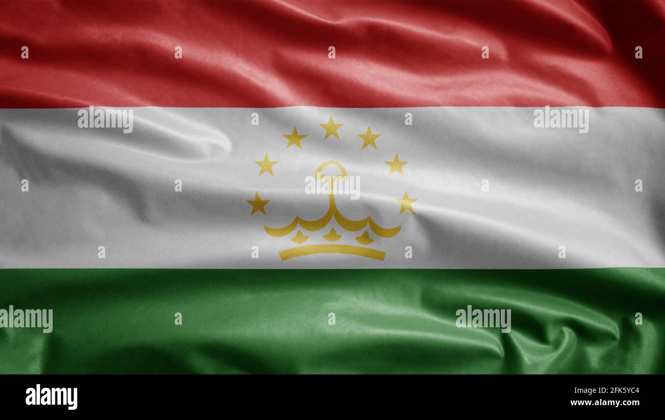 Tajikistani flag waving in the wind. Close up of Tajikistan banner blowing, soft and smooth silk. Cloth fabric texture ensign background. Use it for n Stock Photo