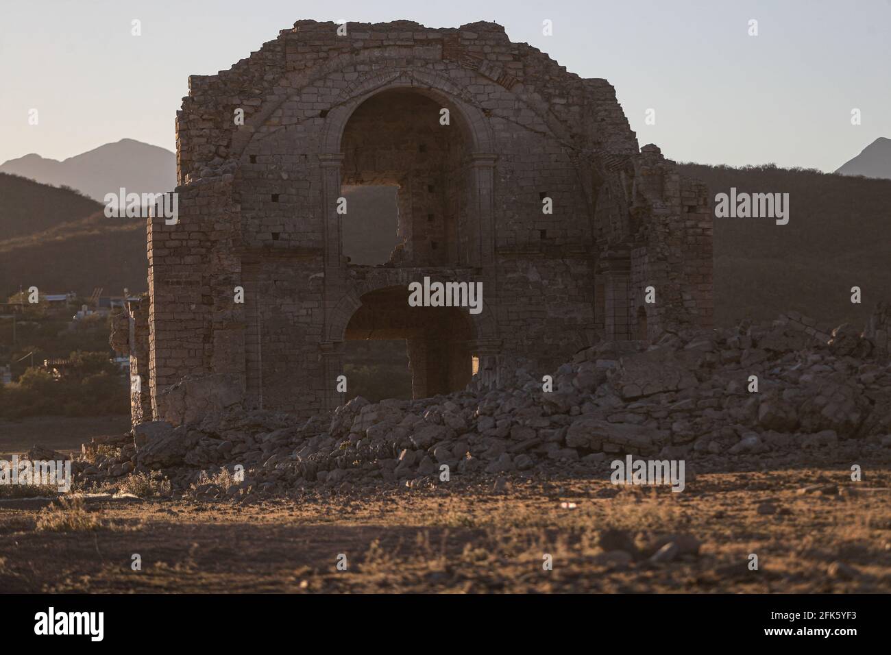 Sunset at the stone ruins of Iglesia San Francisco Javier de Batuc that was submerged in the El Novillo dam in the municipality or town of San Pedro de la Cueva, in Sonora Mexico. ruins exposed by low water level and drought in the northwestern region of Mexico. (Photo By Luis Gutierrez / Norte Photo). Atardecer en las Ruinas de piedra de Iglesia San Francisco Javier de Batuc que se encontraba sumergida en la presa el Novillo en el municipio o pueblo San Pedro de la Cueva, en Sonora Mexico. ruinas al descubierto por el bajo nivel del agua y sequia en la region noroeste de Mexico. (Photo Stock Photo