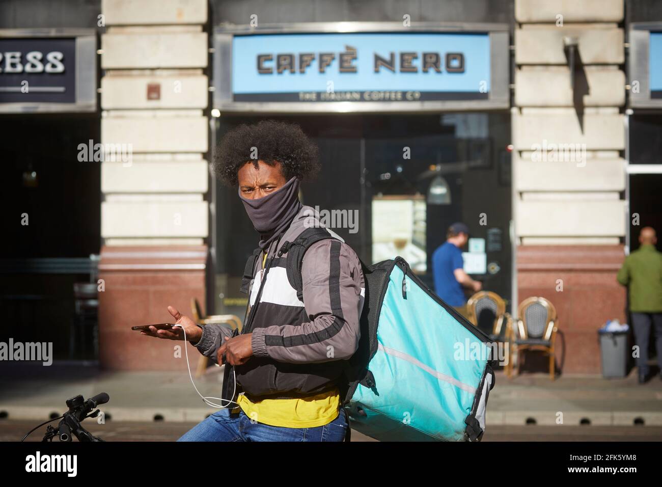 bike rider cycle courier Deliveroo online food delivery company Stock Photo