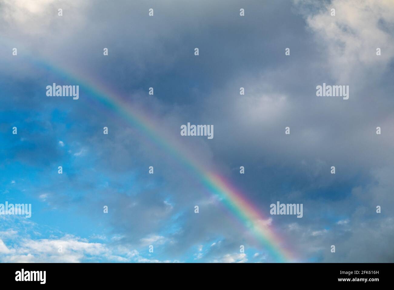 Dark Clouds In Sky And Rainbow