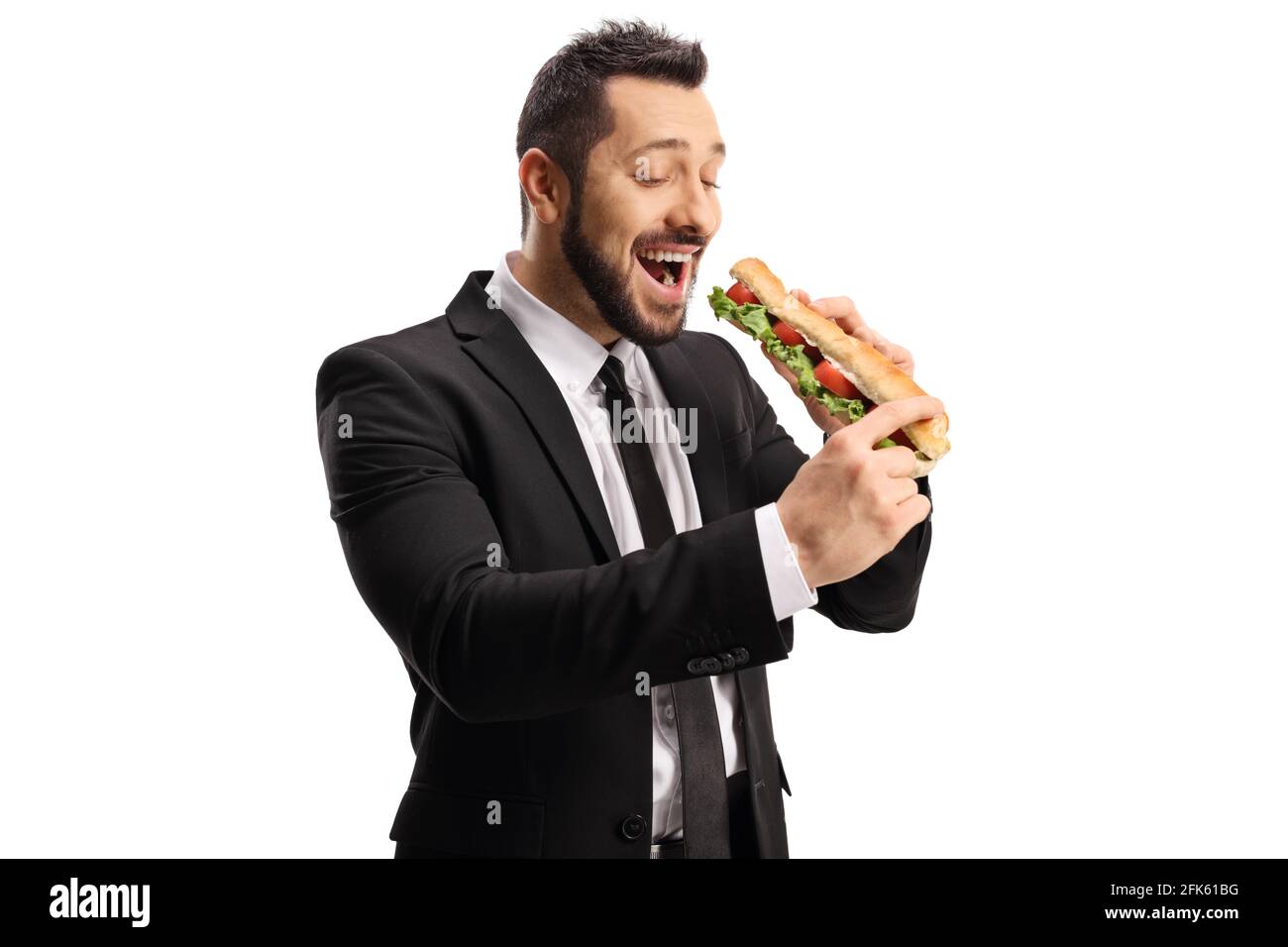Young professional man eating a sandwich in a baguette isolated on white background Stock Photo