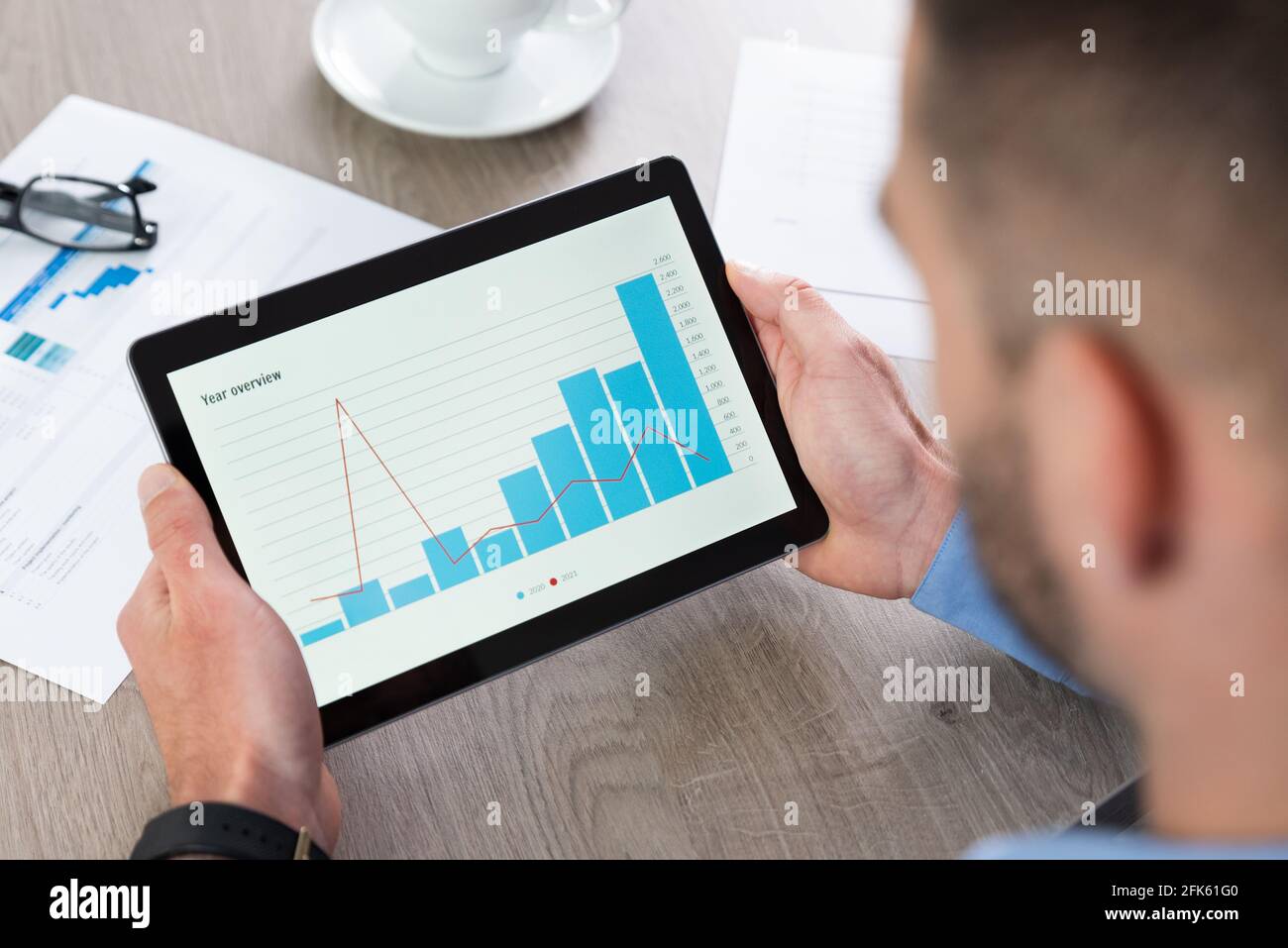 Businessman using tablet computer at work. Financial, analytics chart on tablet Stock Photo