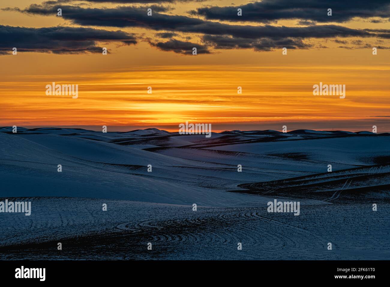 Sunset over Snow Covered Fields Stock Photo