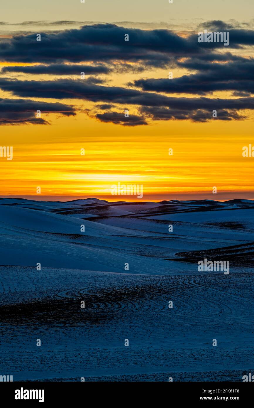 Sunset over Snow Covered Fields Stock Photo