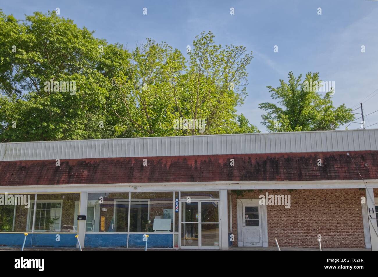 Augusta, Ga USA - 04 27 21: Old wide view vintage closed abandoned barber shop - Deans bridge road Stock Photo