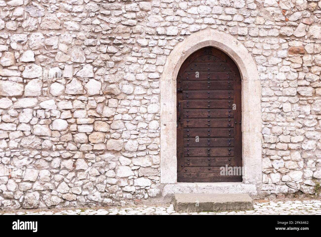 Stone wall with door. Old masonry and an old wooden door in the castle ...