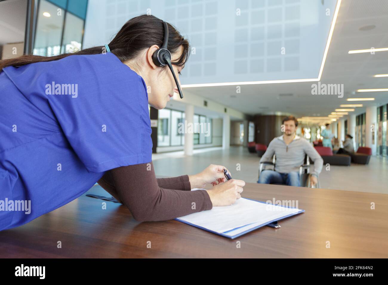 hospital life concept - nurse welcoming patients Stock Photo - Alamy