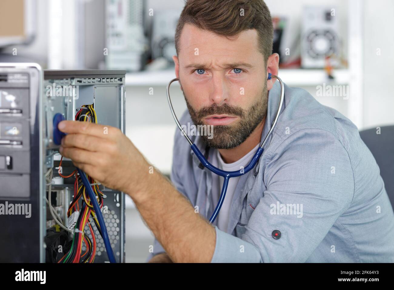 computer engineer working on broken console in his office Stock Photo