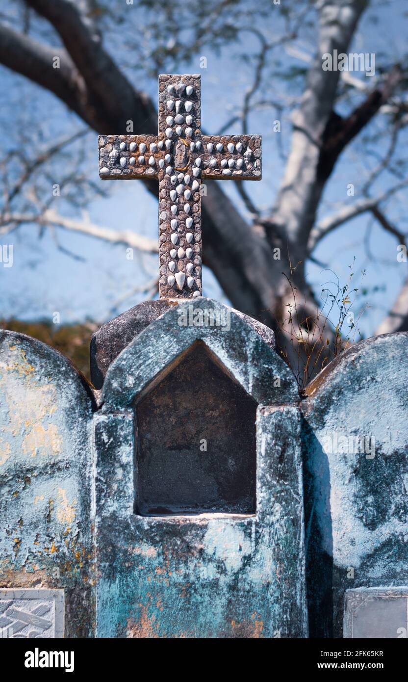 Mexican tomb with cross decorated with seashells. Yucatan, Mexico. Stock Photo