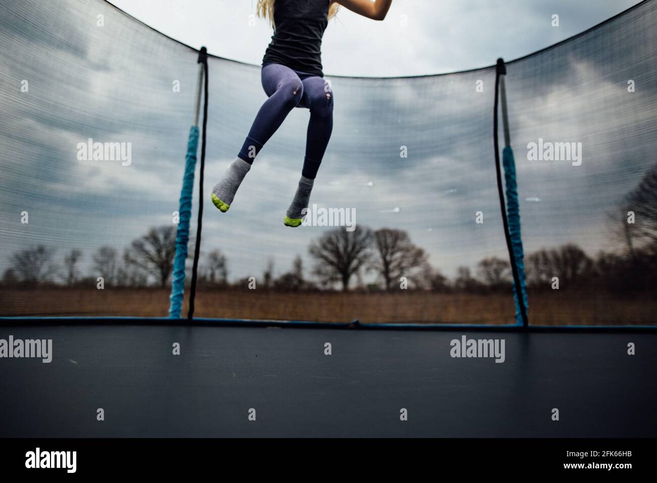 young girl jumping on a trampoline Stock Photo - Alamy
