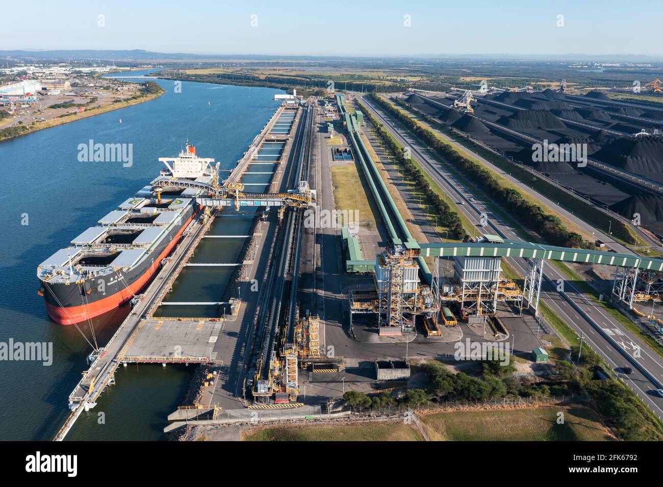 25 April 2021 - Newcastle, NSW, Australia. Aerial view of Japanese bulk carrier NAGARA MARU being loaded with coal and coal loading structures. Stock Photo