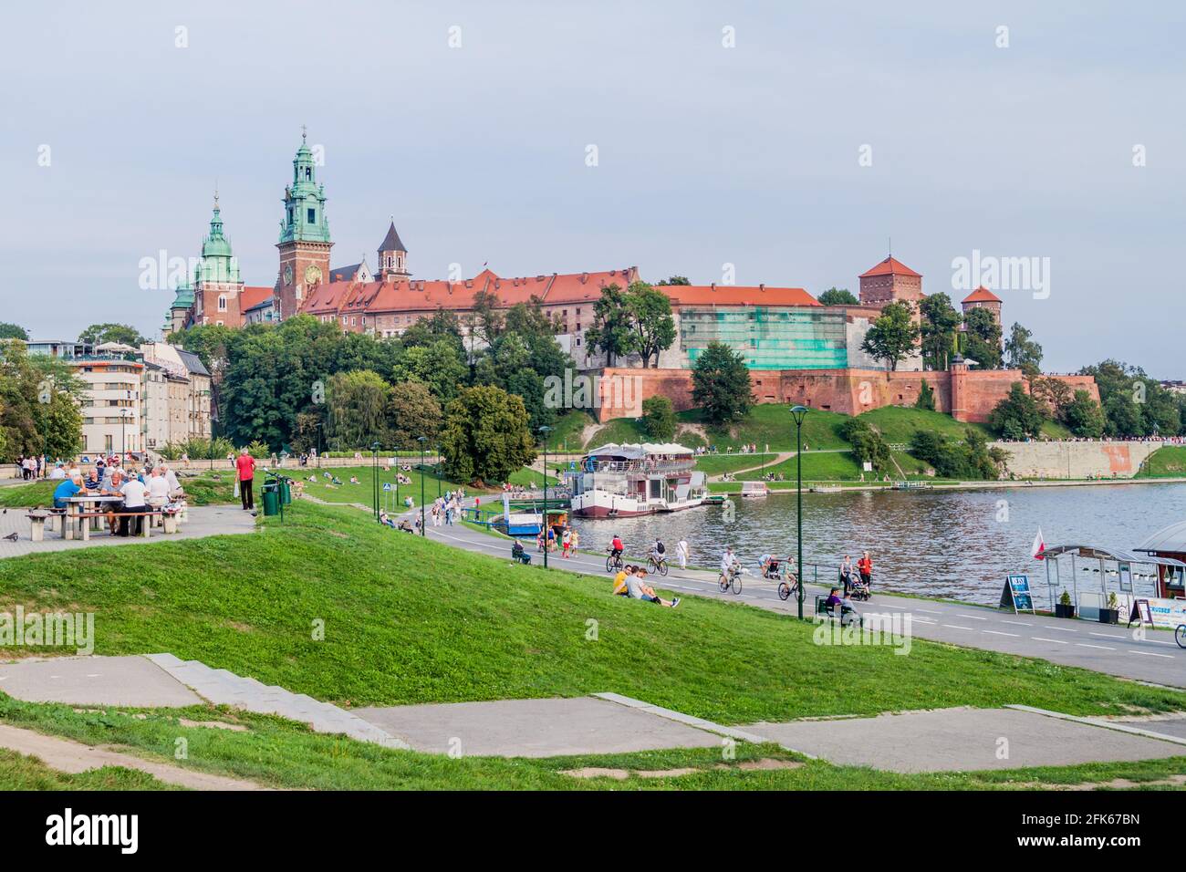 KRAKOW, POLAND - SEPTEMBER 4, 2016: People walk along Vistula river, in front of Wawel castle in Krakow, Poland Stock Photo