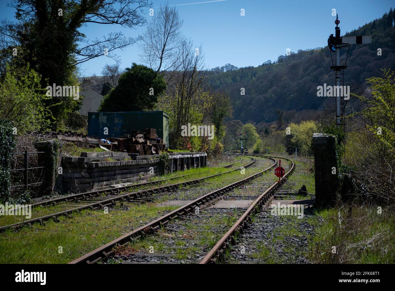 a pair of railway lines heading towards Llangollen station with signals on the side of the track Stock Photo