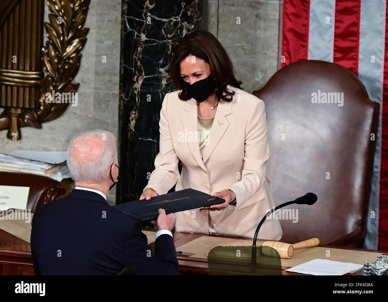 US President Joe Biden gives a copy of his speech to US Vice President Kamala Harris as he arrives to addresses a joint session of Congress at the US Capitol in Washington, DC, on April 28, 2021. Credit: Jim Watson/Pool via CNP /MediaPunch Stock Photo