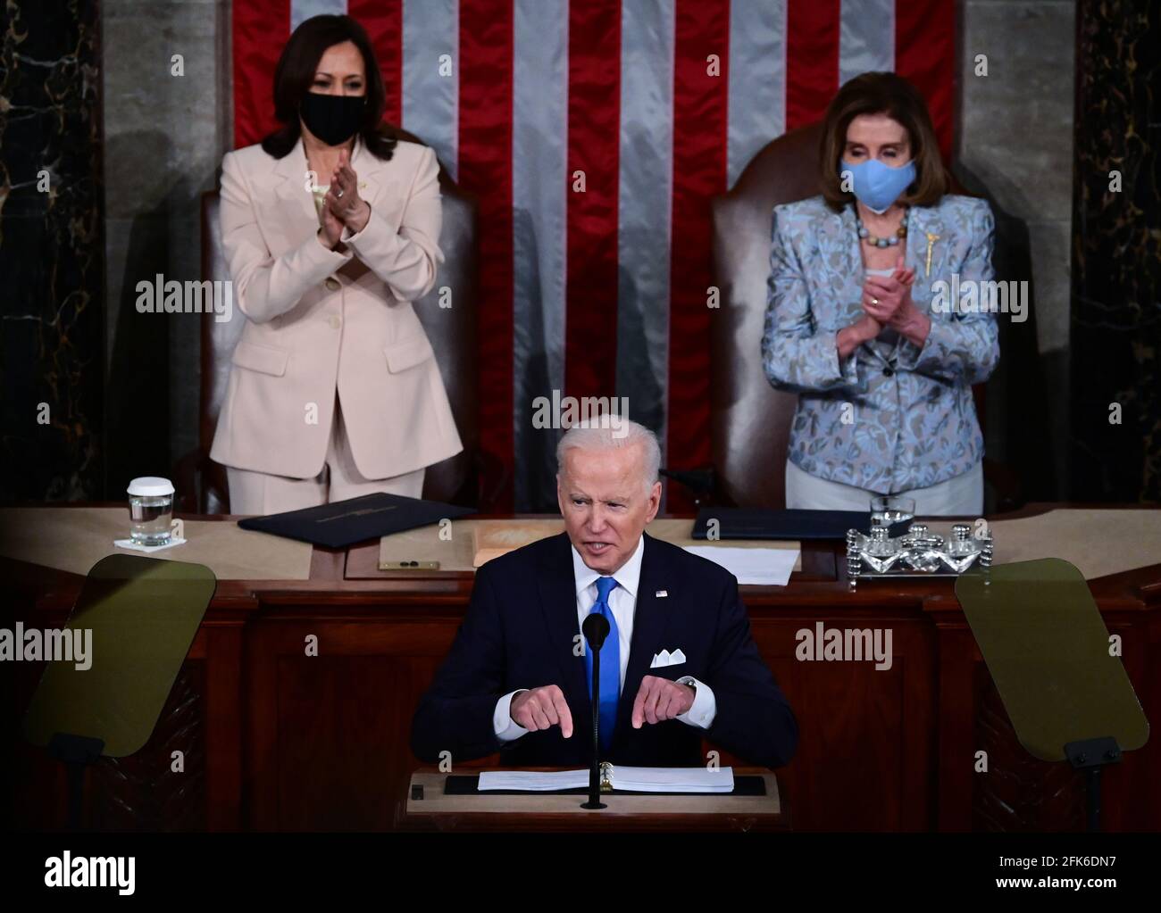 Washington, United States Of America. 28th Apr, 2021. US President Joe Biden addresses a joint session of Congress as US Vice President Kamala Harris (C) and Speaker of the United States House of Representatives Nancy Pelosi (D-CA) react at the US Capitol in Washington, DC, on April 28, 2021. (Photo by Jim WATSON/POOL/AFP)Credit: Jim Watson/Pool via CNP Photo via Credit: Newscom/Alamy Live News Stock Photo