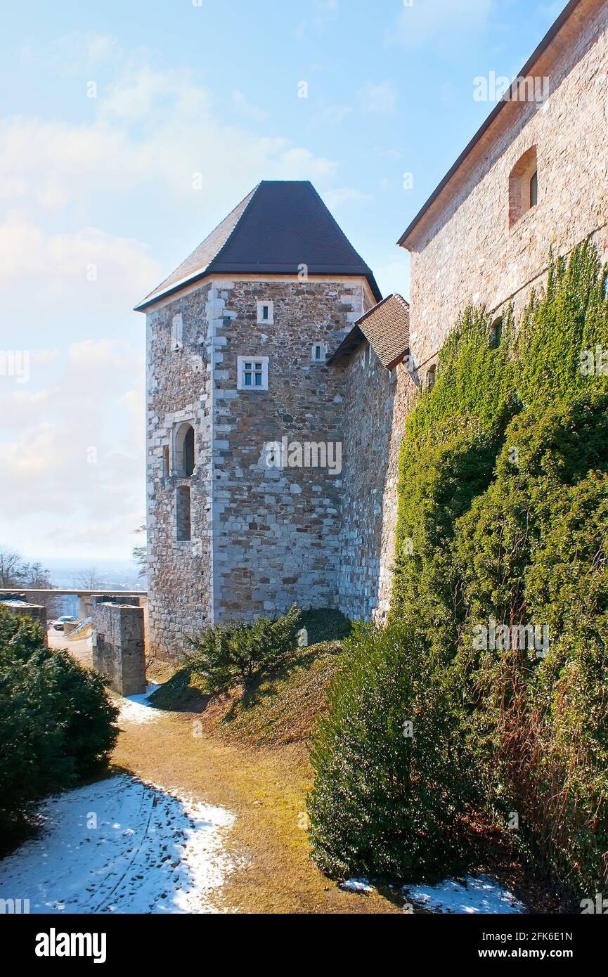 The massive rampart and the tall Pentagonal Tower of the medieval Ljubljana Castle, Slovenia Stock Photo