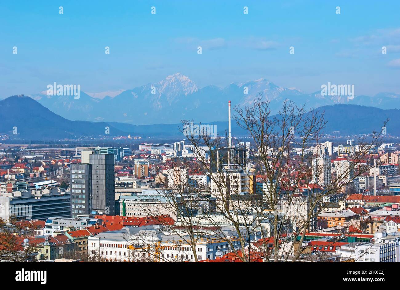 Watch the city from the Ljubljanski Grad (Castle) and enjoy the view of Julian Alps behind the modern districts, Ljubljana, Slovenia Stock Photo