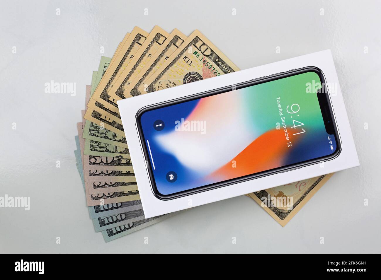 BANGKOK, THAILAND - JANUARY 2018 : Box of new iPhone X (iPhone 10) on American banknote money on marble background on January 17, 2018 in Bangkok, Tha Stock Photo