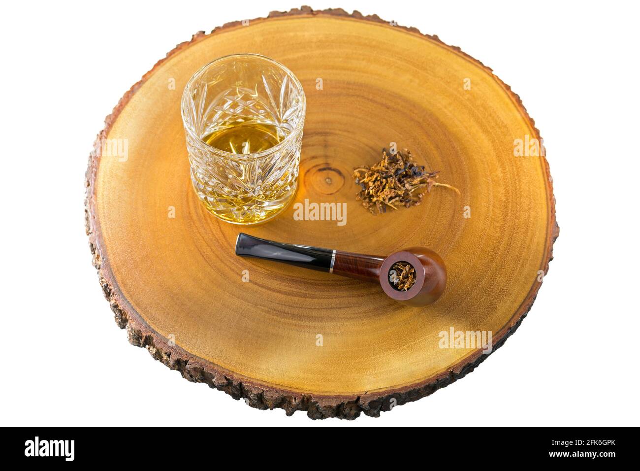 Glass of single malt scotch whisky next to aromatic pipe tobacco on wood isolated on white background Stock Photo