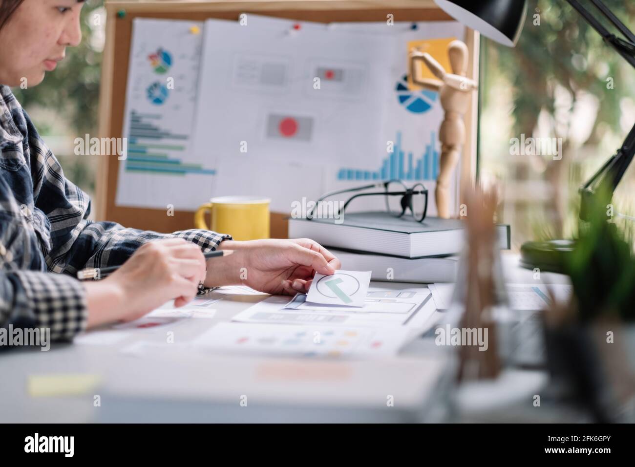 Close up App developer Ux Ui designing with paper model on mobile application prepare Stock Photo