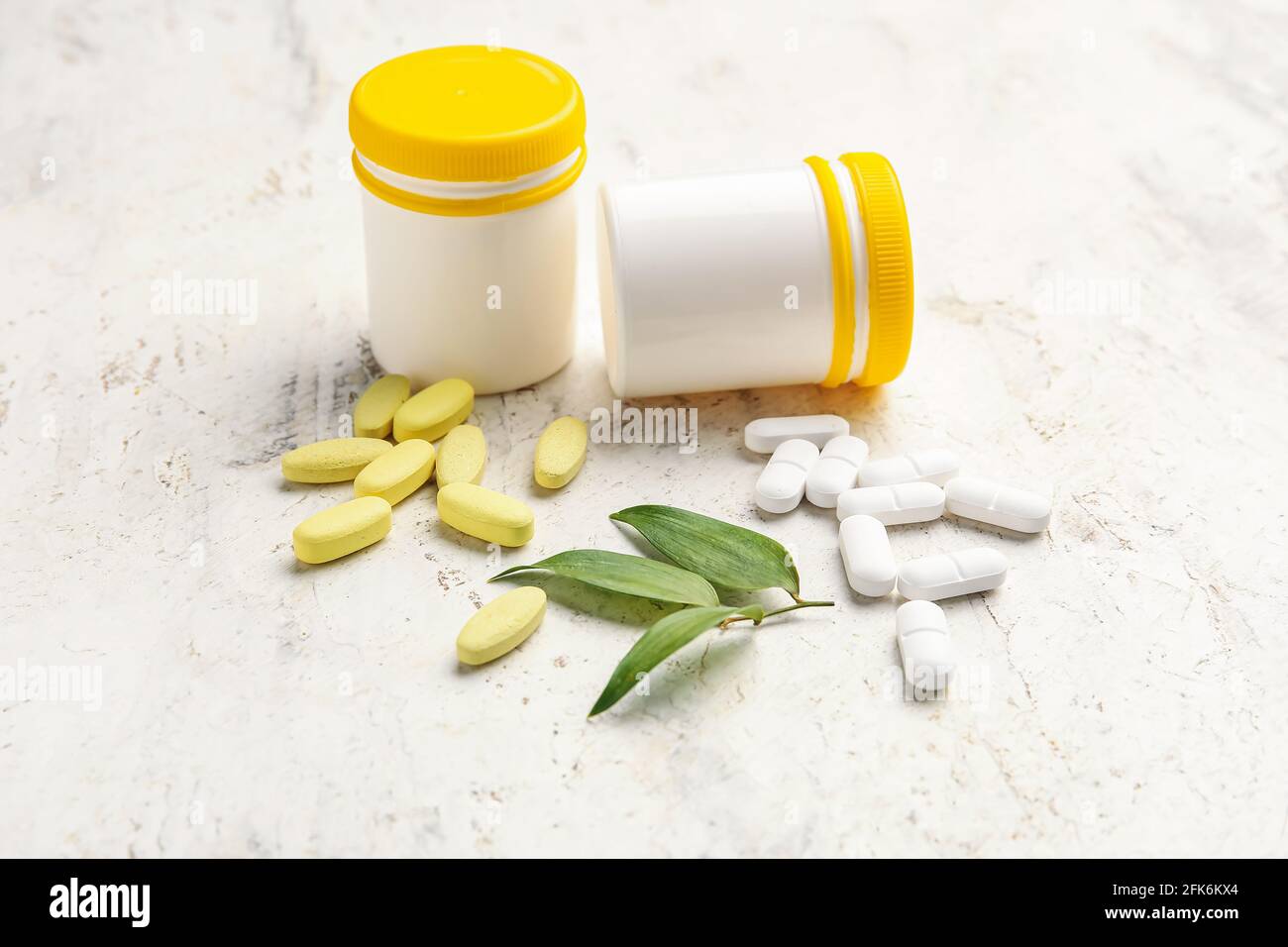 Bottles with different pills on light background Stock Photo