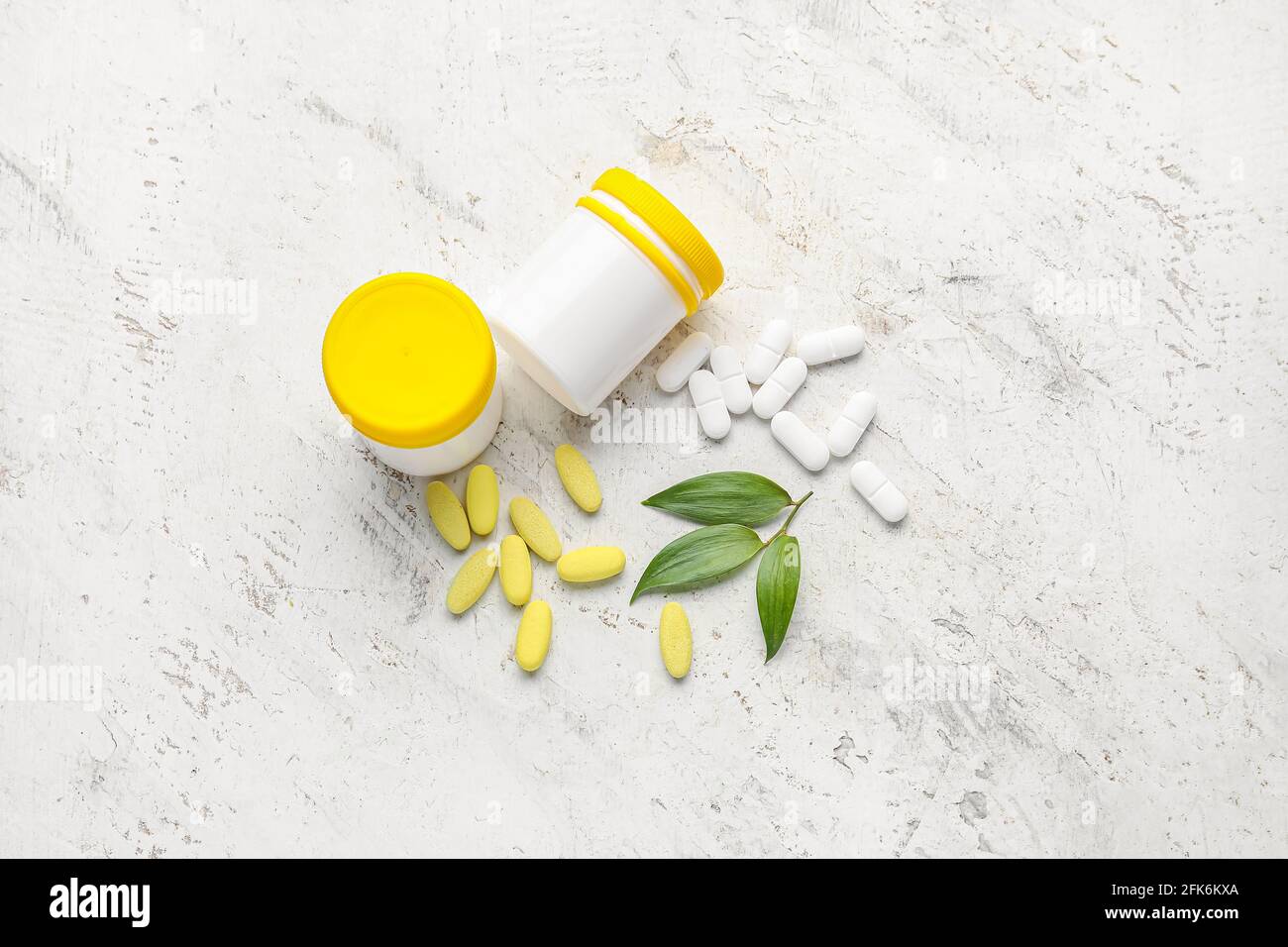 Bottles with different pills on light background Stock Photo