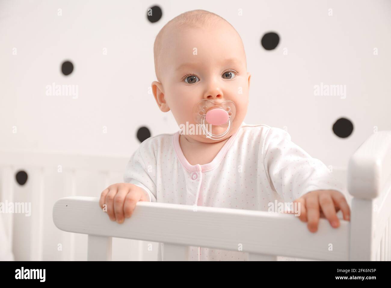 Cute little baby in crib at home Stock Photo Alamy