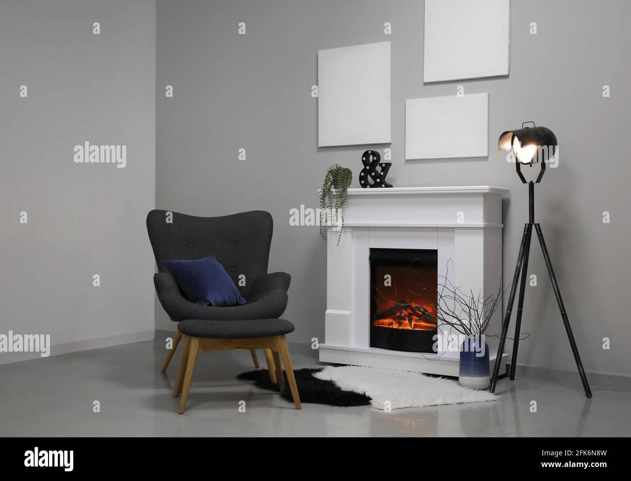 Interior of modern living room with fireplace and armchair Stock Photo ...