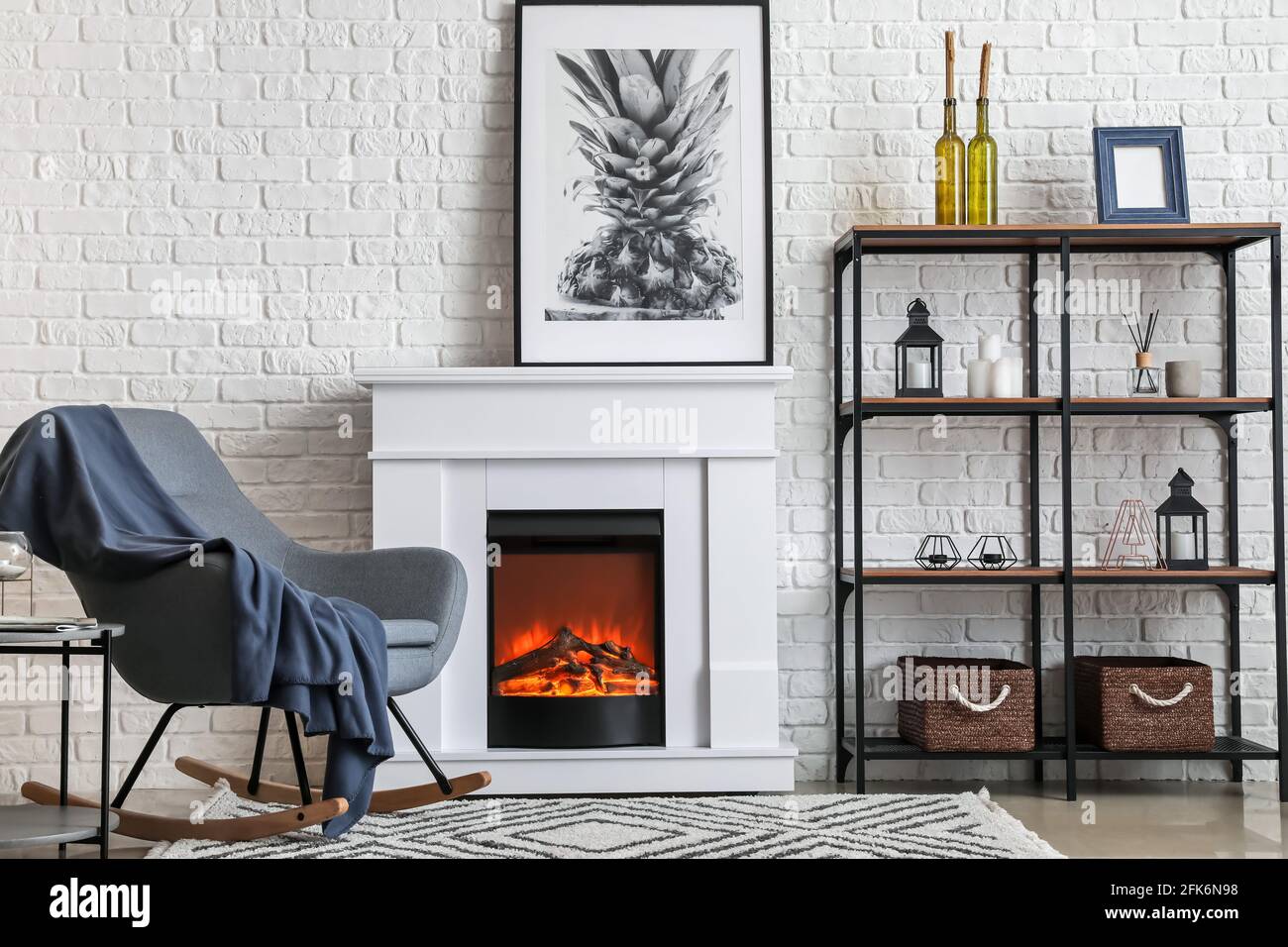 Interior of modern living room with fireplace and armchair Stock Photo ...