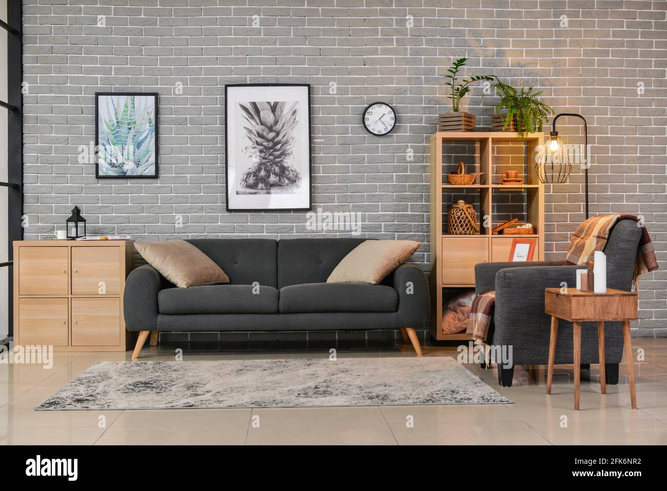 Interior of stylish living room with sofa and armchair Stock Photo - Alamy