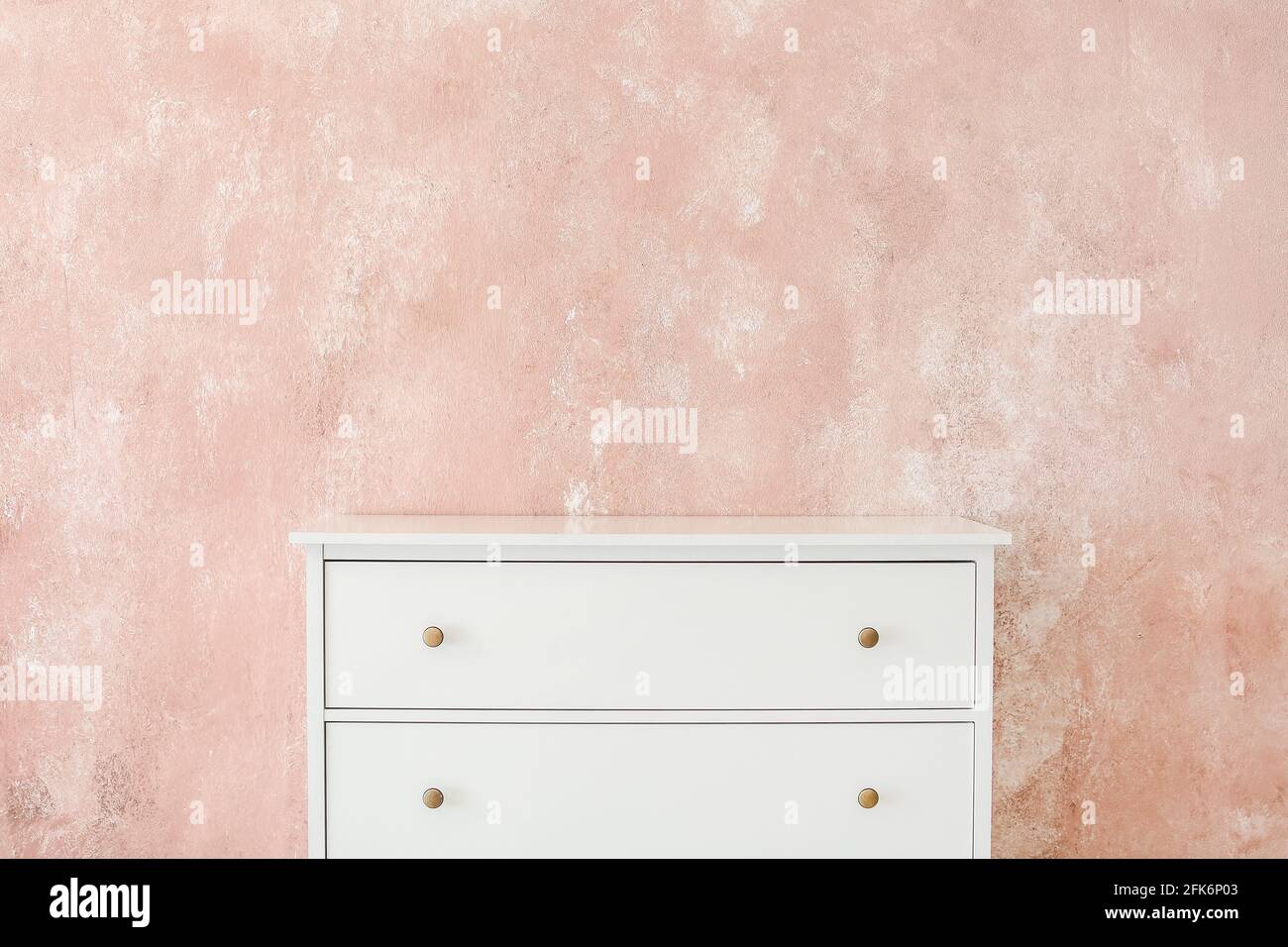 Stylish chest of drawers near color wall Stock Photo - Alamy
