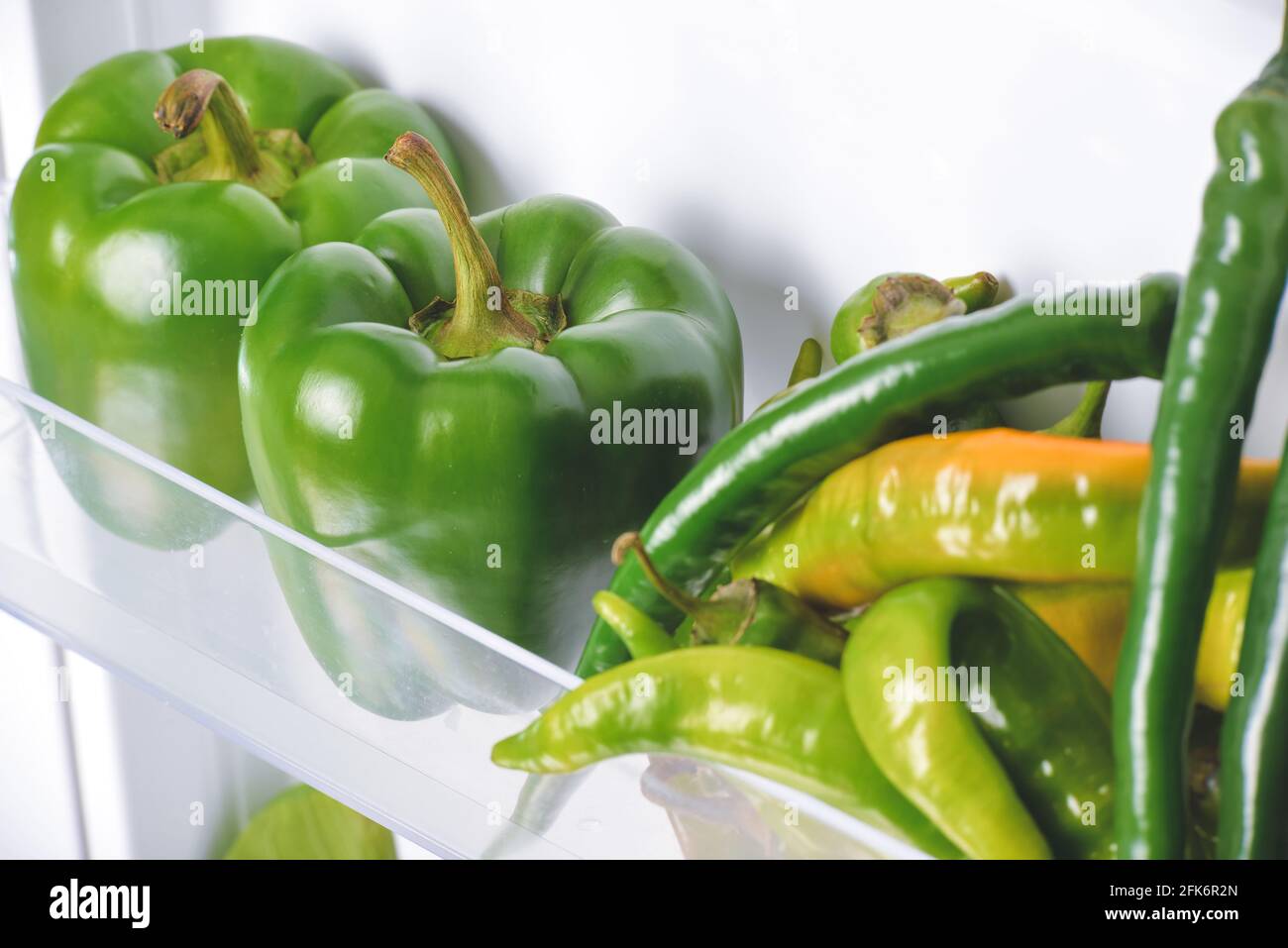 Fresh green peppers in fridge, closeup Stock Photo Alamy