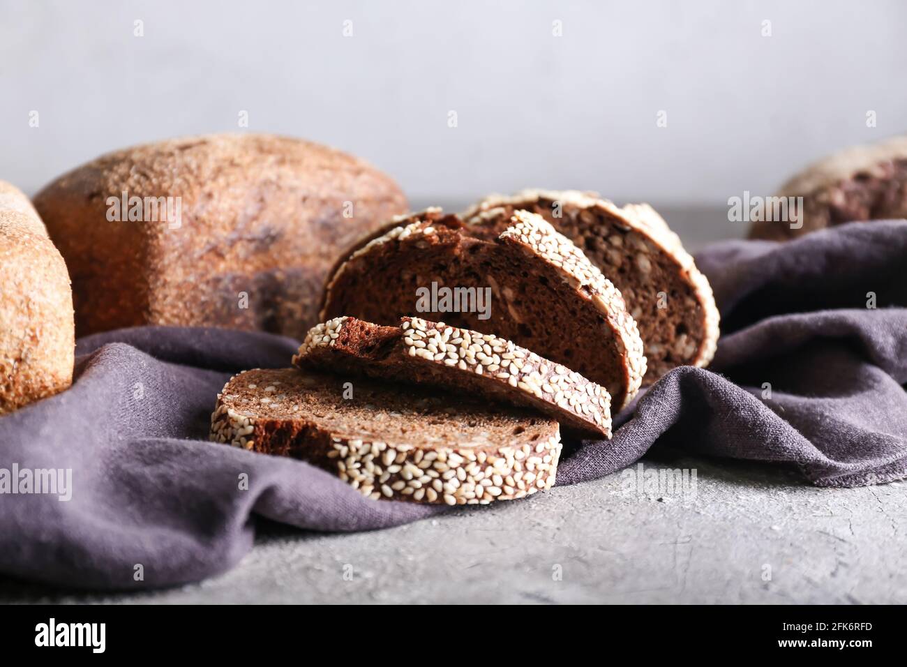 Fresh cut bread on grey background Stock Photo - Alamy