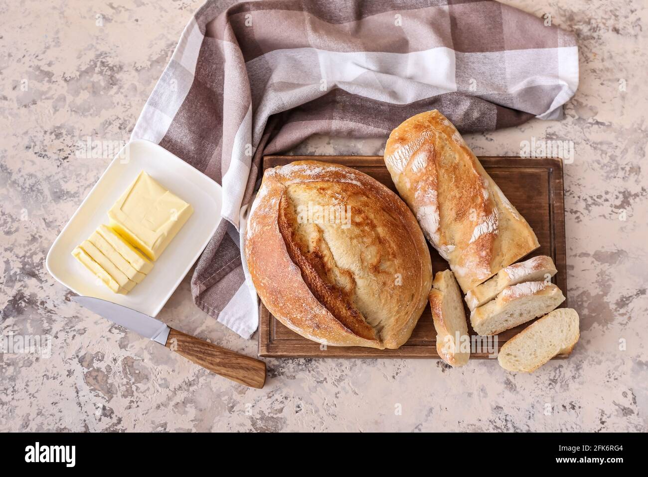Board with fresh cut bread on grunge background Stock Photo - Alamy