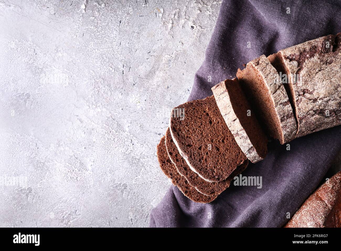 Fresh cut bread on grey background Stock Photo - Alamy