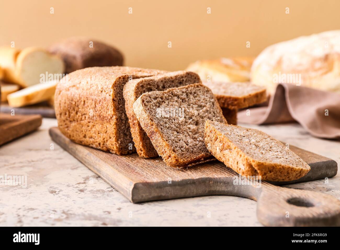 Board with fresh cut bread on grunge background Stock Photo - Alamy