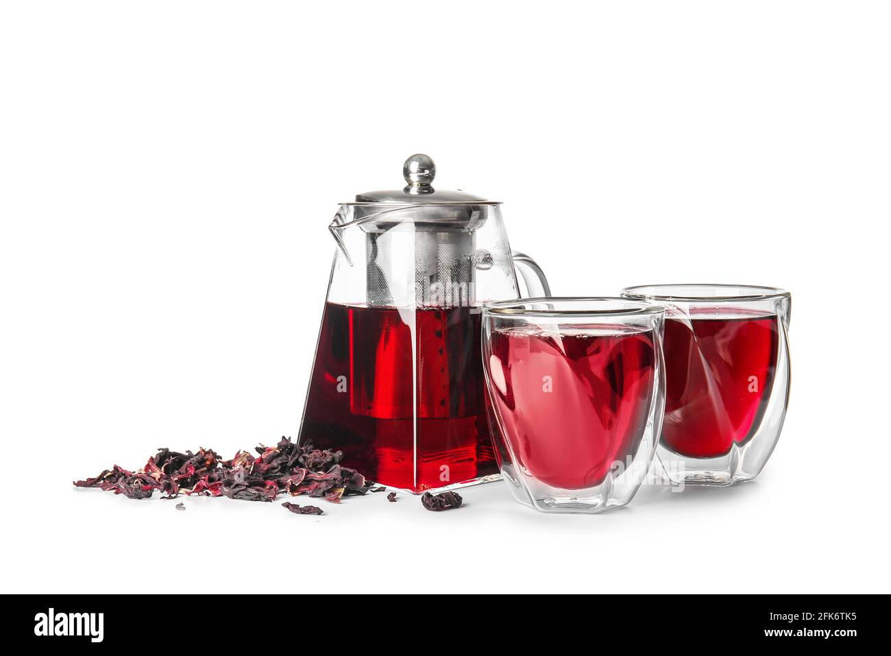 Teapot with hot tea, glasses and dry leaves on white background Stock Photo