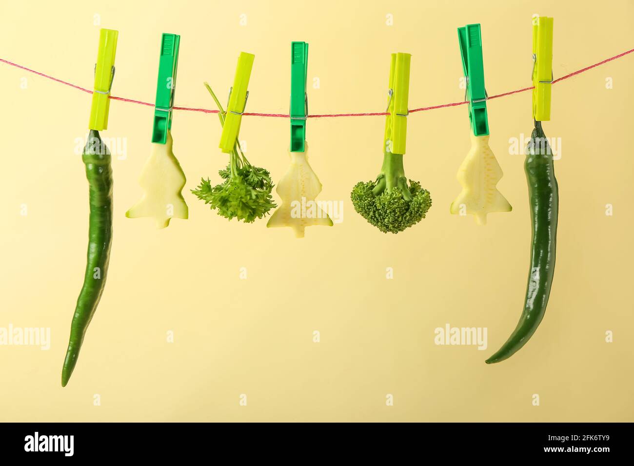 Food Save Rope Fresh vegetables hanging on rope against color background Stock Photo ...