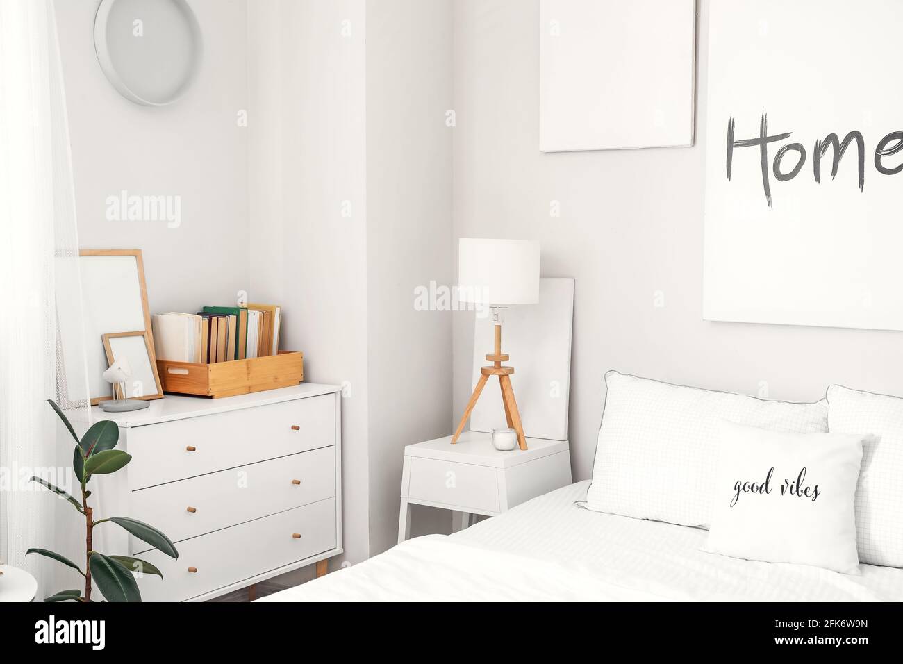 Modern bedside table with lamp in interior of room Stock Photo - Alamy