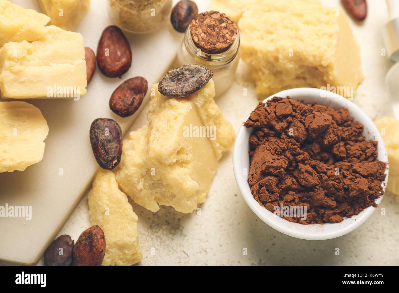 Cocoa butter, powder and beans on light background, closeup Stock Photo Alamy