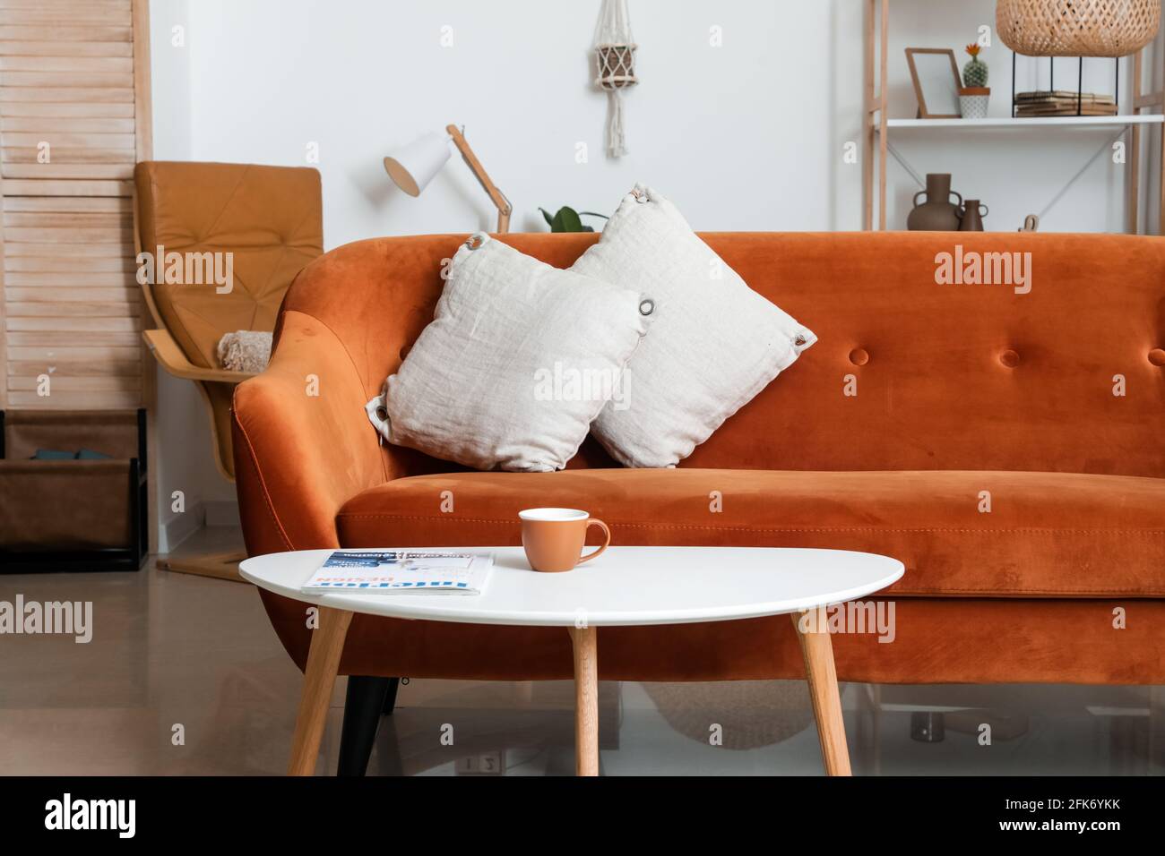 Stylish interior of living room with comfortable sofa and table Stock ...