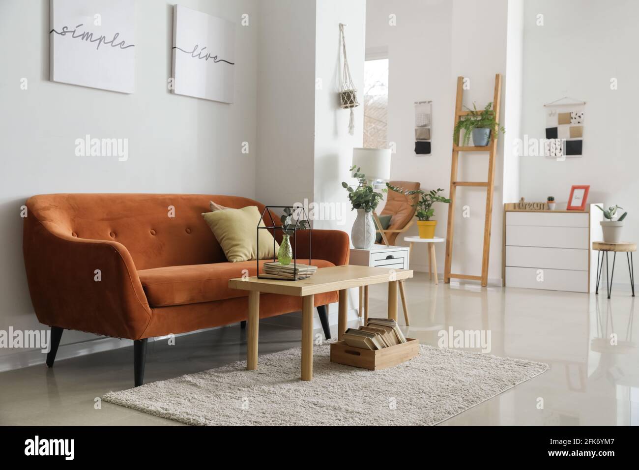 Stylish interior of room with comfortable sofa and table Stock Photo ...