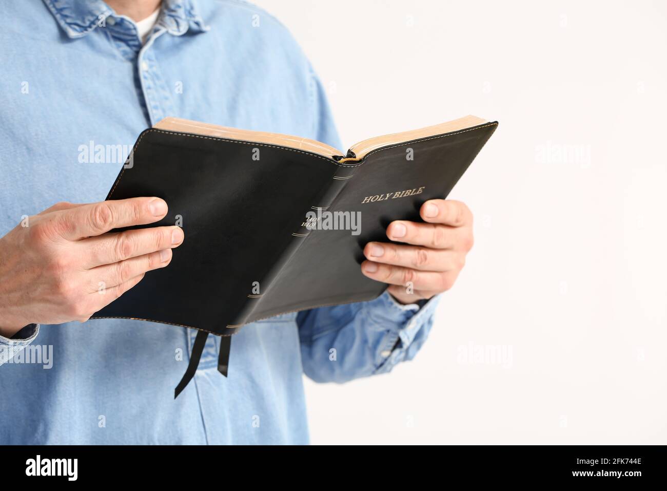 Man with Bible on white background, closeup Stock Photo